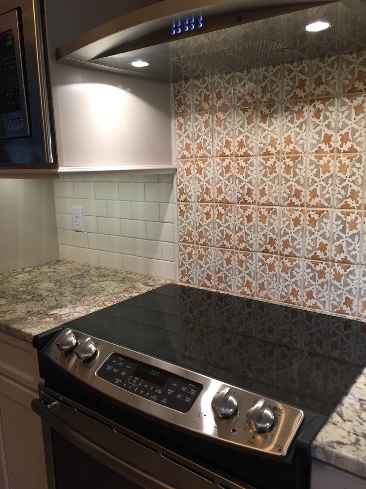 Inspiration for a rustic brown floor kitchen remodel in Cincinnati with a double-bowl sink, raised-panel cabinets, beige cabinets, granite countertops, white backsplash, terra-cotta backsplash and stainless steel appliances