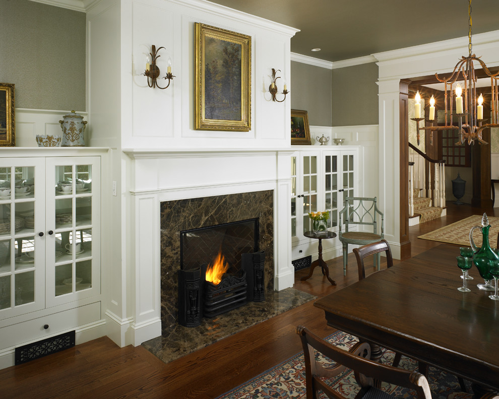 Design ideas for a mid-sized traditional separate dining room in Boston with green walls, medium hardwood floors, a standard fireplace and a stone fireplace surround.