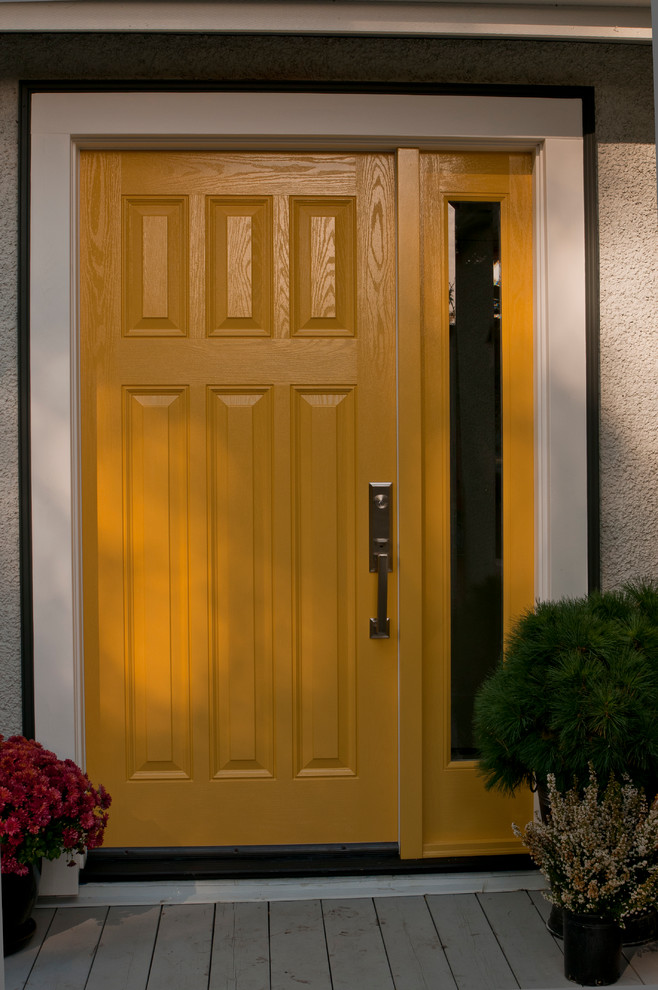 This is an example of a traditional front door in Vancouver with grey walls, a single front door and a yellow front door.
