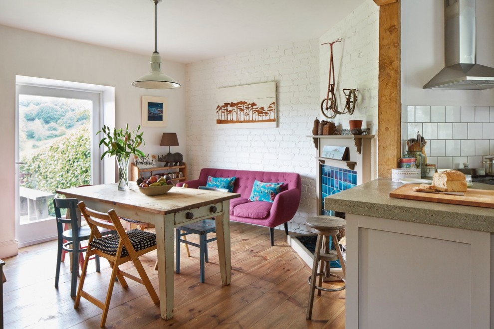 Design ideas for an eclectic kitchen/dining combo in Devon with light hardwood floors.