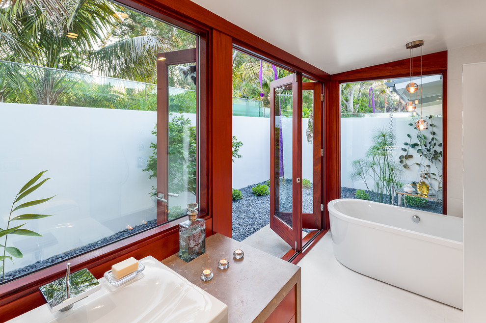 Photo of a tropical bathroom in Santa Barbara with a vessel sink and a freestanding tub.