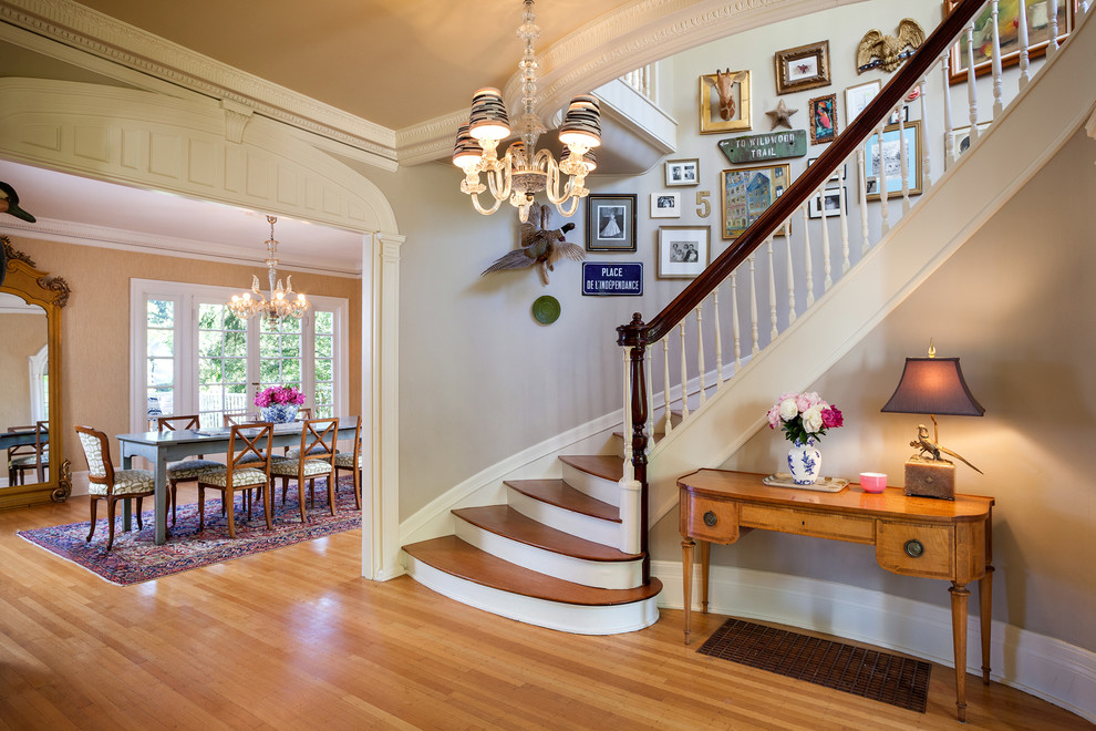 Photo of a traditional wood curved staircase in Portland.