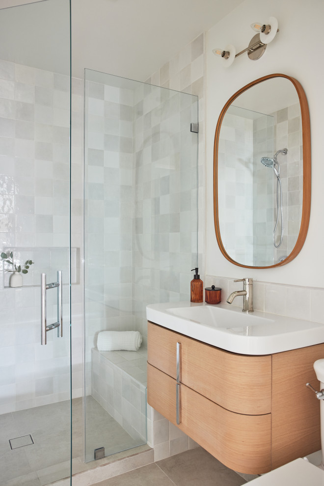 This is an example of a large midcentury 3/4 bathroom in Los Angeles with light wood cabinets, white tile, ceramic tile, white walls, light hardwood floors, an integrated sink, engineered quartz benchtops, beige floor, a hinged shower door, white benchtops, a single vanity, a floating vanity, a niche and flat-panel cabinets.