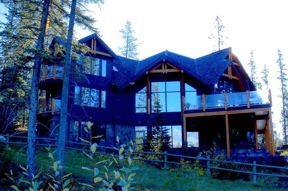Huge mountain style backyard deck photo in Calgary