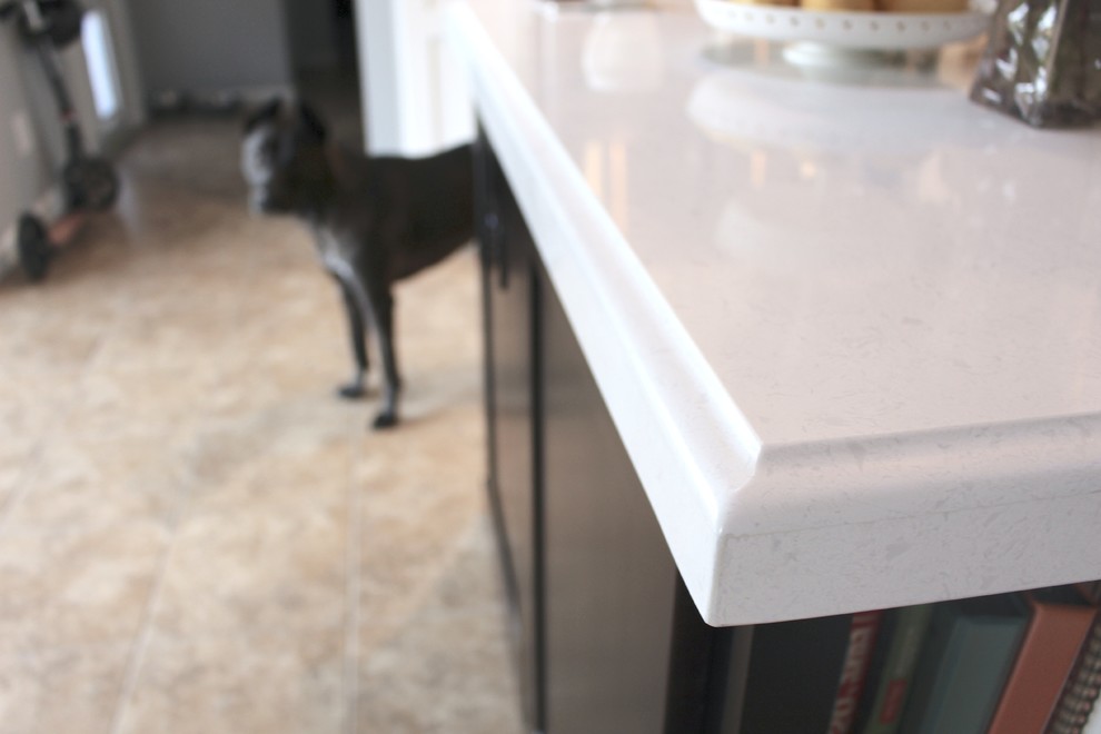 Large transitional l-shaped ceramic tile and beige floor open concept kitchen photo in Phoenix with an undermount sink, shaker cabinets, white cabinets, quartzite countertops, gray backsplash, stainless steel appliances and an island