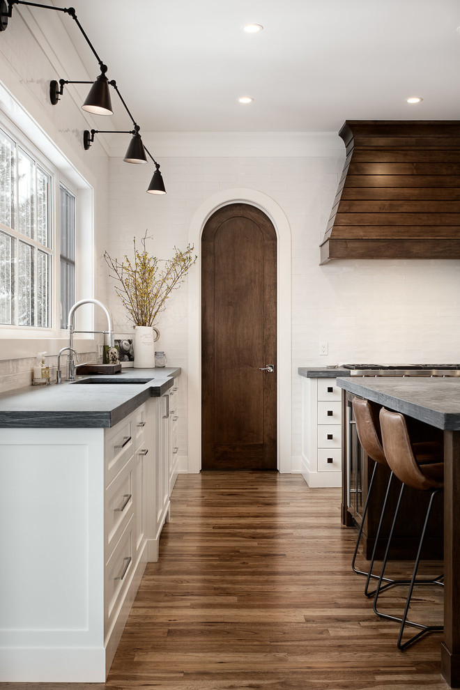 Inspiration for a large transitional u-shaped eat-in kitchen remodel in Calgary with shaker cabinets, paneled appliances and an island