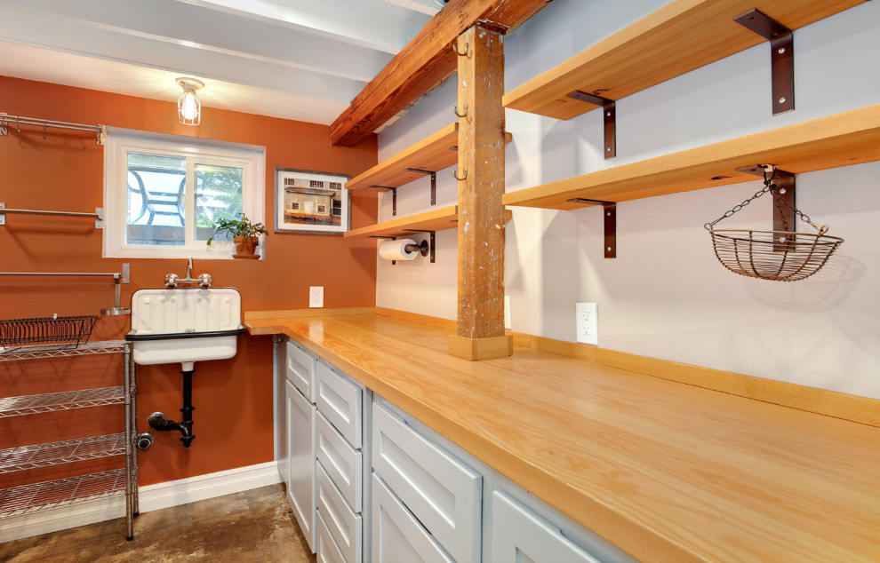 Small country l-shaped separate kitchen in Portland with a farmhouse sink, shaker cabinets, grey cabinets, wood benchtops, concrete floors and no island.