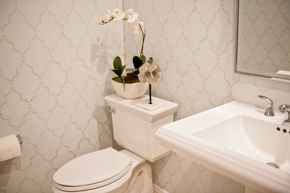 Inspiration for a small transitional powder room in Phoenix with a two-piece toilet, blue walls and a pedestal sink.