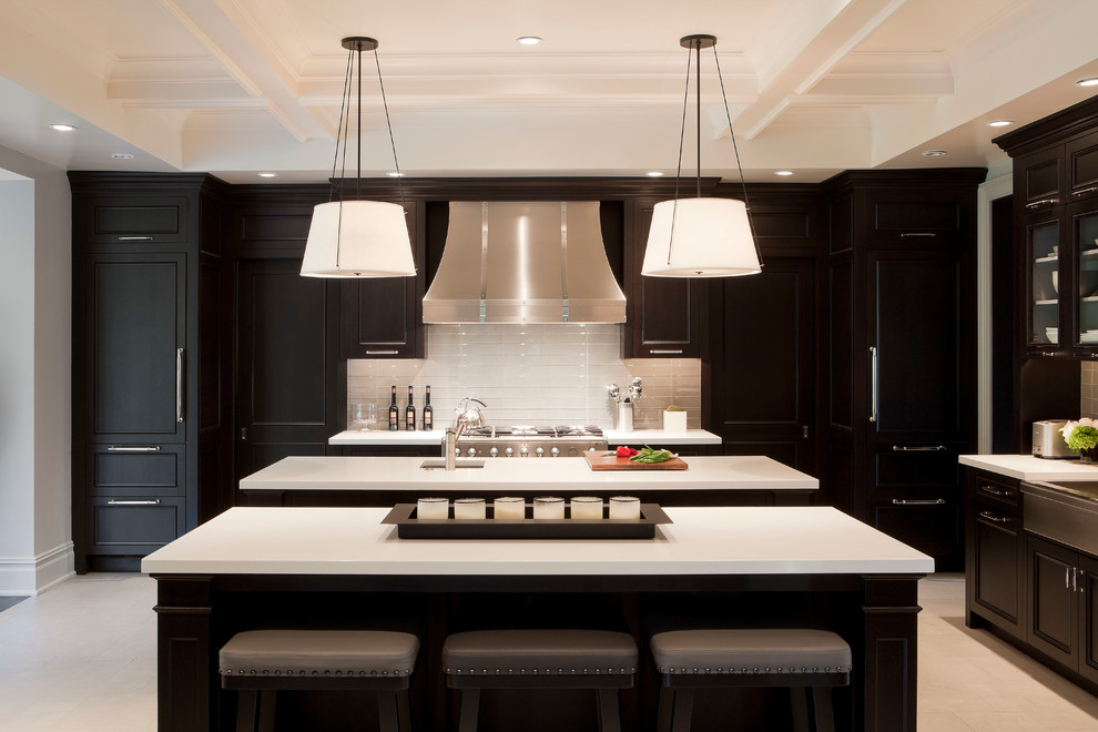 Photo of a transitional kitchen in New York with a farmhouse sink, recessed-panel cabinets, black cabinets, beige splashback and panelled appliances.