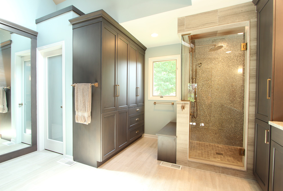 Photo of a large transitional master bathroom in Other with recessed-panel cabinets, grey cabinets, an alcove shower, a two-piece toilet, multi-coloured tile, glass sheet wall, grey walls, limestone floors, an undermount sink, engineered quartz benchtops, grey floor, a hinged shower door and beige benchtops.