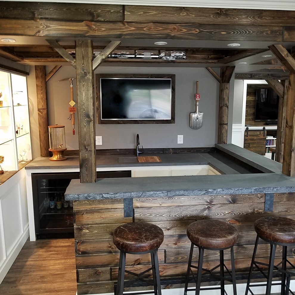 This is an example of a large contemporary u-shaped seated home bar in Minneapolis with an integrated sink, recessed-panel cabinets, white cabinets, concrete benchtops, brown splashback, timber splashback, medium hardwood floors and brown floor.