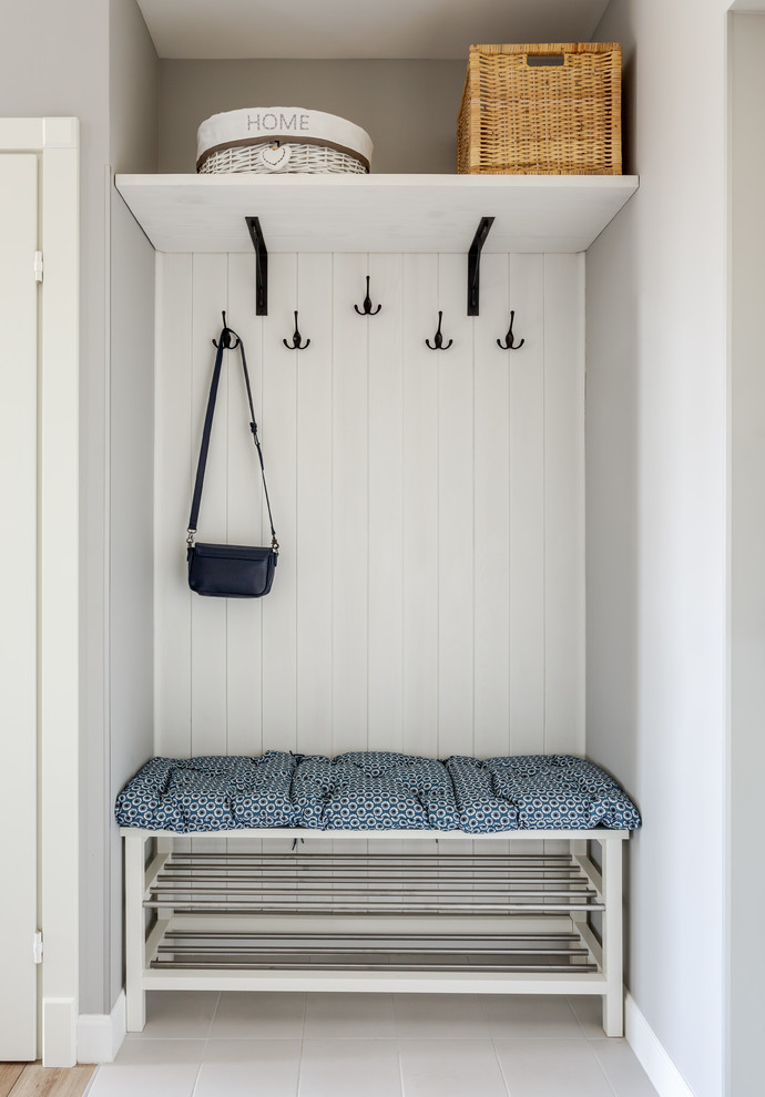 Design ideas for a scandinavian mudroom in Moscow with grey walls and grey floor.