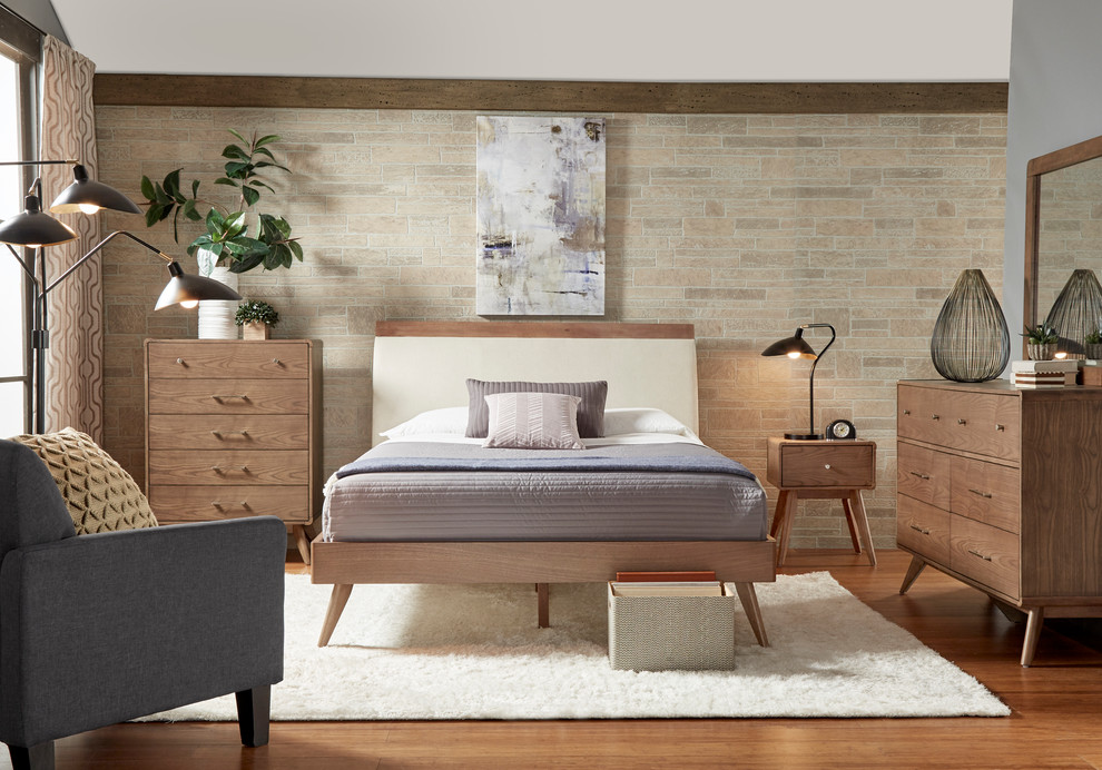 Small midcentury guest bedroom in Chicago with beige walls and brick floors.