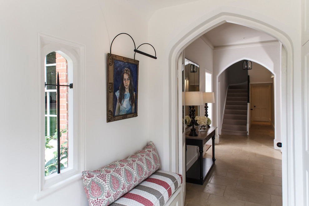 Traditional entryway in Cambridgeshire with white walls and limestone floors.