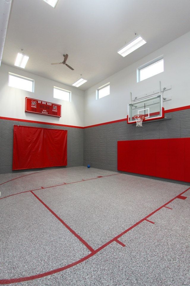 This is an example of a large contemporary indoor sport court in Omaha with grey walls, linoleum floors and grey floor.