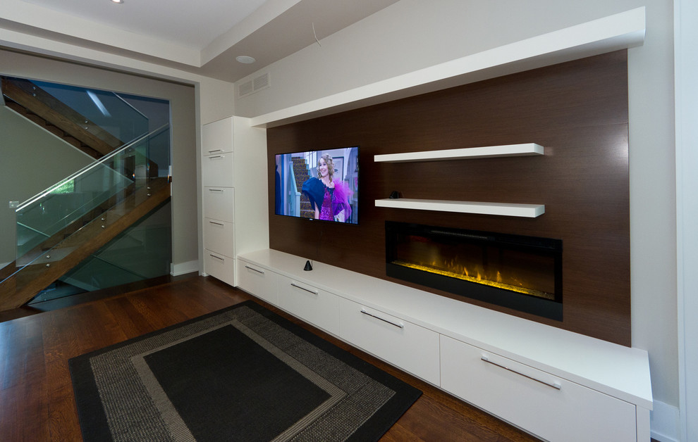 This is an example of a mid-sized modern open concept home theatre in Toronto with grey walls, light hardwood floors and a wall-mounted tv.