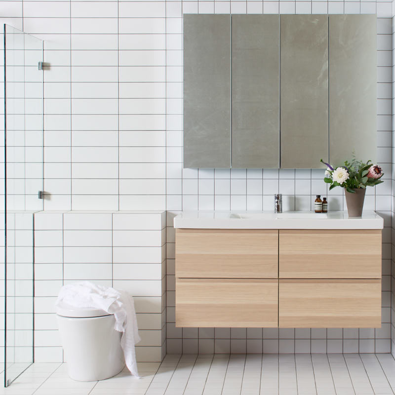 Design ideas for a mid-sized scandinavian 3/4 bathroom in Other with a two-piece toilet, white tile, subway tile, white walls, ceramic floors and a wall-mount sink.
