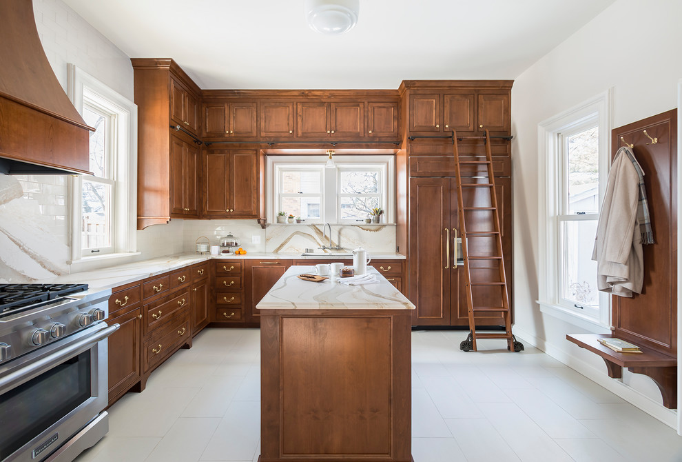 Inspiration for a mid-sized traditional l-shaped separate kitchen in Minneapolis with an undermount sink, beaded inset cabinets, medium wood cabinets, quartz benchtops, stone slab splashback, panelled appliances, porcelain floors, with island, beige floor, white splashback and white benchtop.