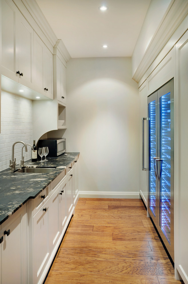 This is an example of a large transitional wine cellar in Toronto with medium hardwood floors.