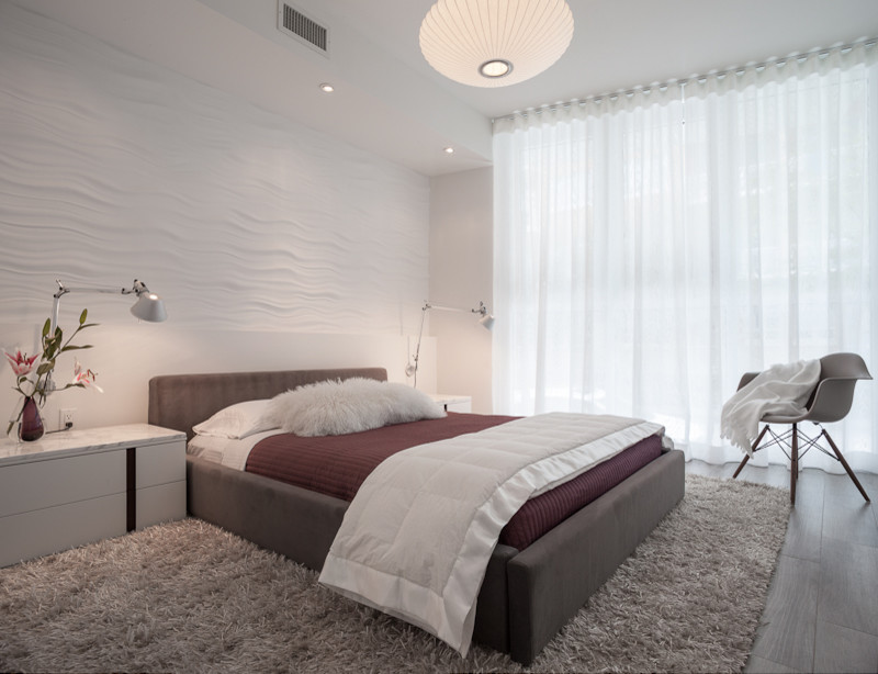 This is an example of a mid-sized modern guest bedroom in Miami with white walls, ceramic floors and no fireplace.