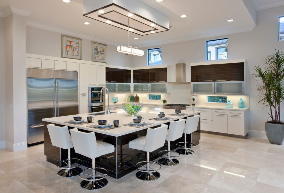 Design ideas for a large contemporary l-shaped kitchen pantry in Miami with an integrated sink, flat-panel cabinets, white cabinets, granite benchtops, white splashback, marble floors, with island and stainless steel appliances.