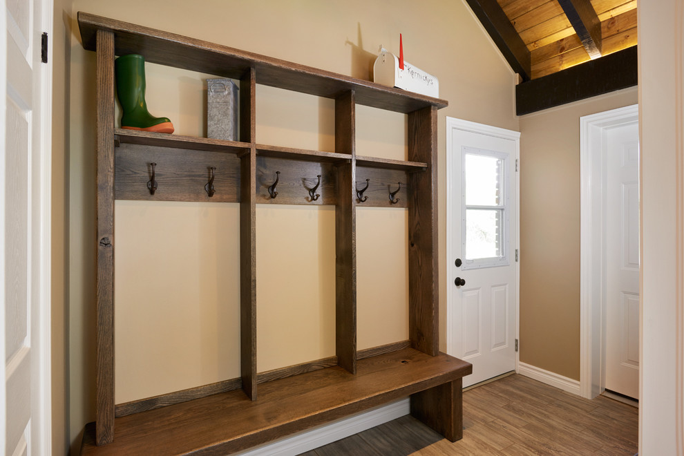 This is an example of a mid-sized country mudroom in Toronto with beige walls, porcelain floors, a single front door and a white front door.