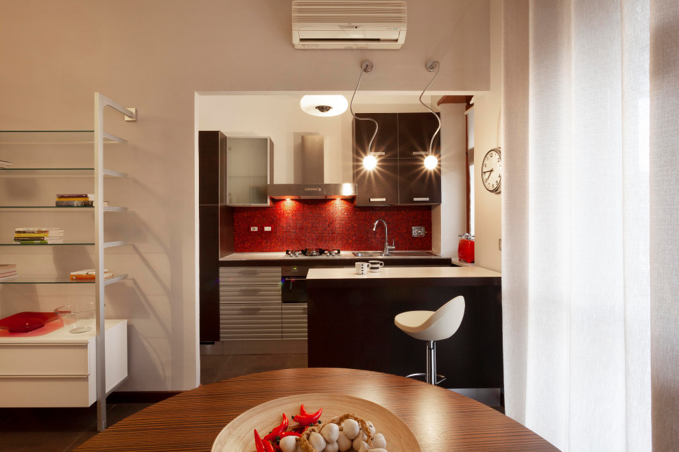 Photo of a small contemporary single-wall kitchen/diner in Turin with a single-bowl sink, flat-panel cabinets, dark wood cabinets, laminate countertops, red splashback, mosaic tiled splashback, integrated appliances, porcelain flooring, an island, brown floors and white worktops.