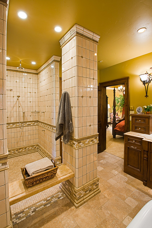 Mountain style master beige tile doorless shower photo with beaded inset cabinets, dark wood cabinets and beige walls