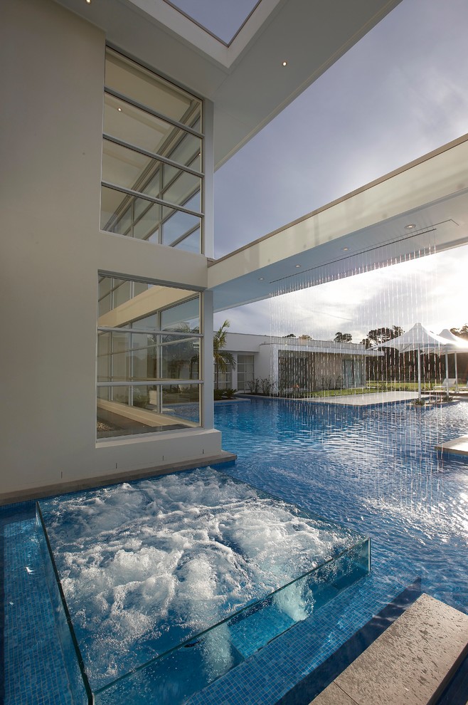 Contemporary custom-shaped pool in Sydney with a hot tub.