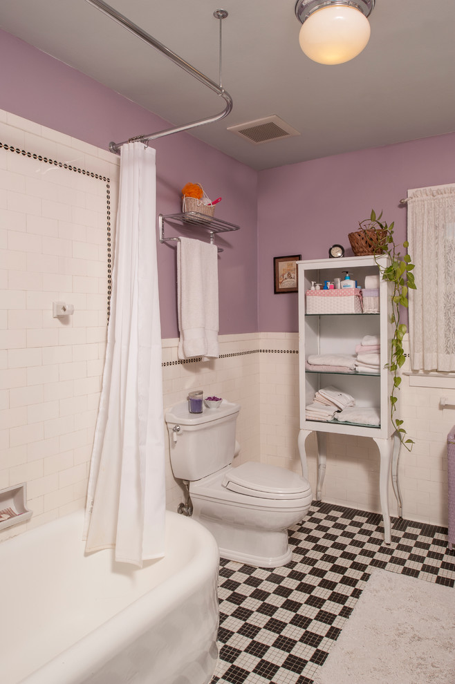 Design ideas for a mid-sized traditional bathroom in Detroit with furniture-like cabinets, white cabinets, a corner tub, a shower/bathtub combo, a two-piece toilet, subway tile, purple walls, ceramic floors, an undermount sink and marble benchtops.