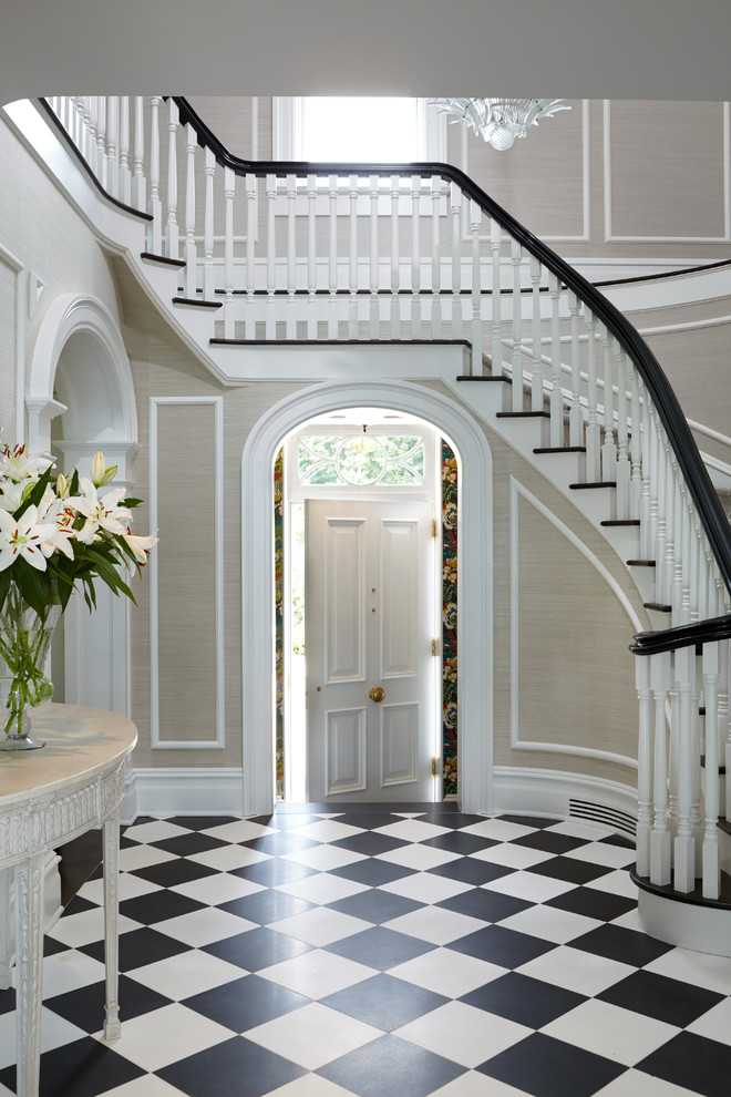 Photo of a mid-sized traditional foyer in New York with beige walls, marble floors, a single front door, a white front door and multi-coloured floor.