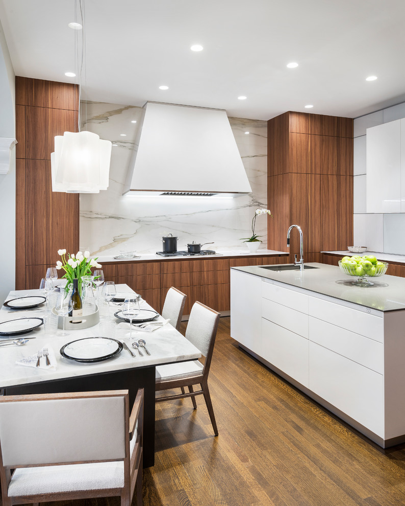 Mid-sized contemporary eat-in kitchen in Miami with an integrated sink, flat-panel cabinets, medium wood cabinets, quartzite benchtops, white splashback, stone slab splashback, medium hardwood floors, with island, brown floor and white benchtop.