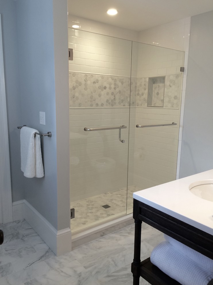 Photo of a transitional 3/4 bathroom in Portland Maine with open cabinets, black cabinets, an alcove shower, gray tile, white tile, subway tile, grey walls, marble floors, an undermount sink, quartzite benchtops, grey floor and a hinged shower door.