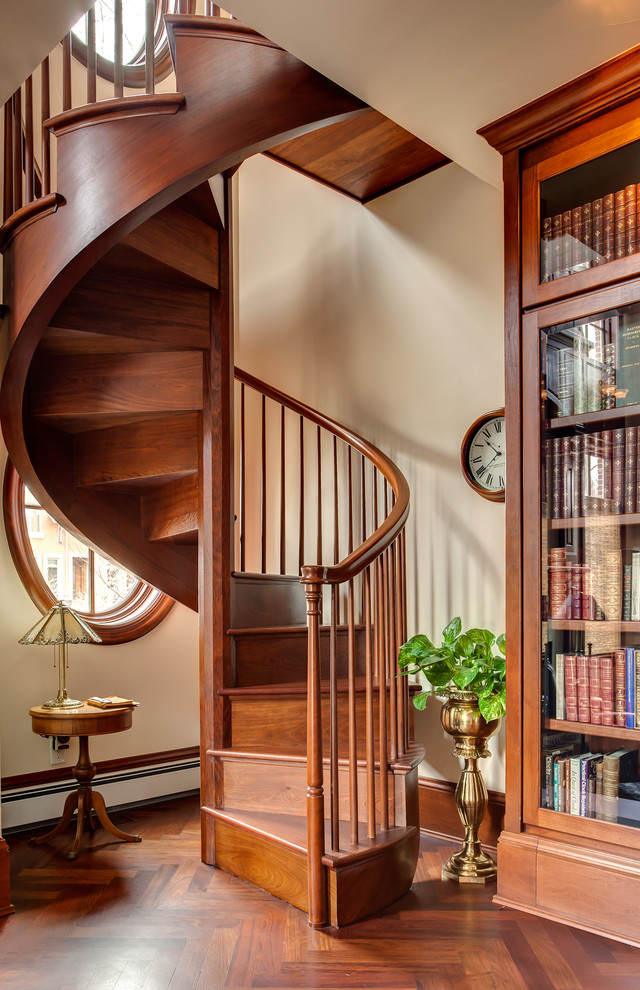 Design ideas for a traditional wood spiral staircase in Denver with wood risers.