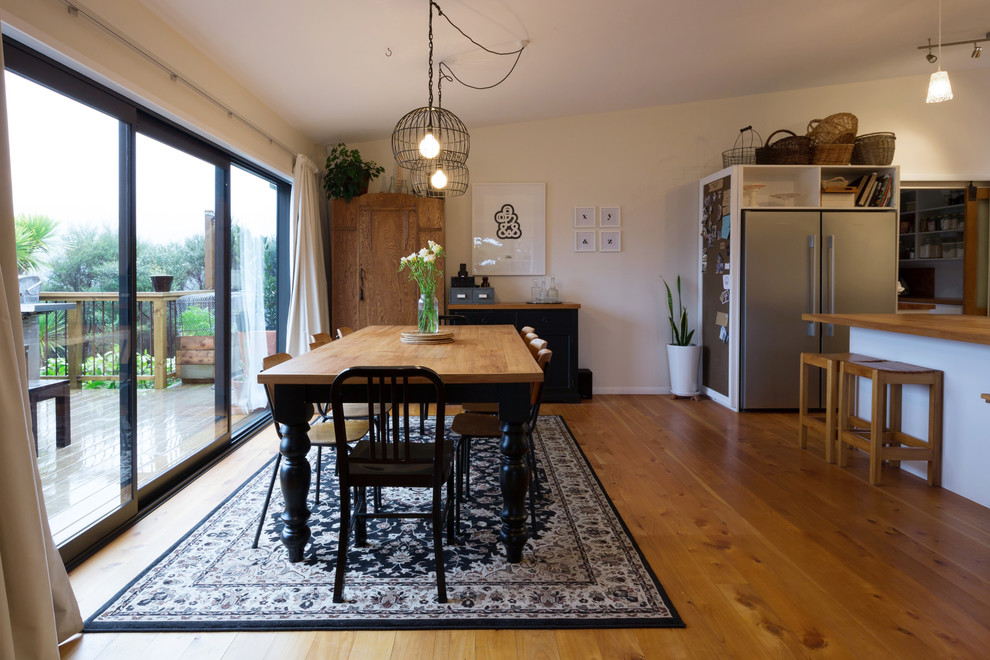 This is an example of a transitional dining room in Auckland.