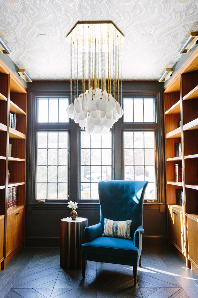 Photo of a mid-sized transitional home office in Chicago with a library, dark hardwood floors and brown floor.
