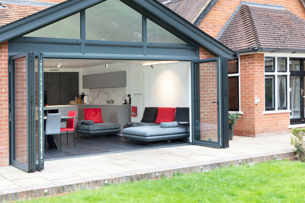 Inspiration for a medium sized modern split-level brick and rear house exterior in Berkshire.