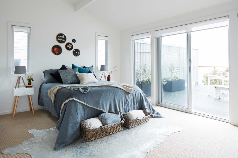 Design ideas for a scandinavian master bedroom in Central Coast with white walls and carpet.