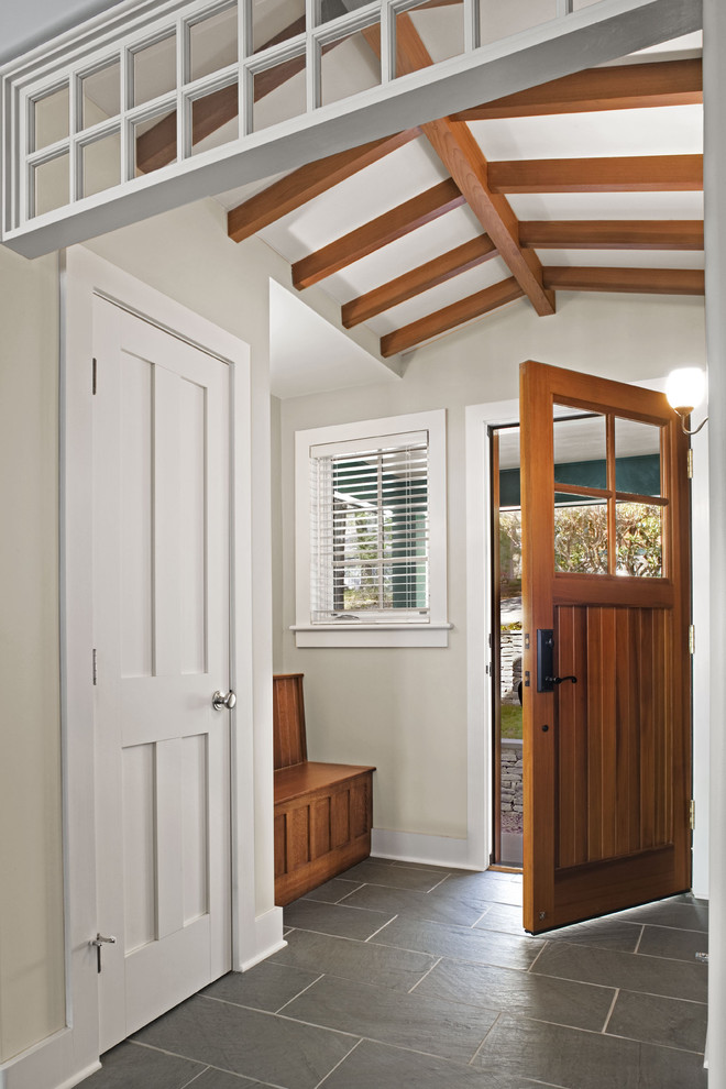 This is an example of a transitional entryway in Bridgeport with a single front door, a medium wood front door and slate floors.
