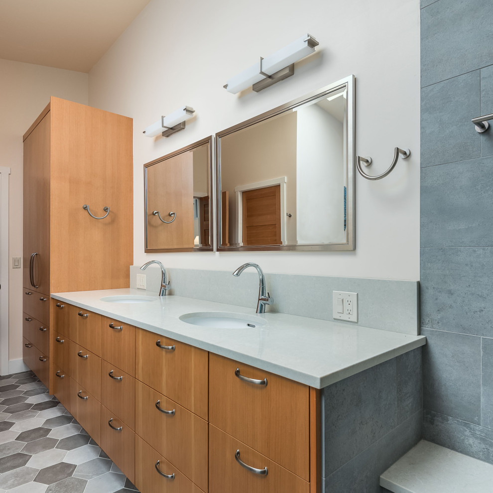 This is an example of a large midcentury master bathroom in Portland with flat-panel cabinets, light wood cabinets, an undermount tub, an open shower, a two-piece toilet, gray tile, stone slab, white walls, light hardwood floors, an undermount sink, engineered quartz benchtops, brown floor, an open shower and white benchtops.