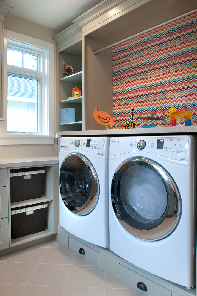 Inspiration for a mid-sized beach style galley utility room in Grand Rapids with recessed-panel cabinets, grey cabinets, laminate benchtops, grey walls, slate floors and a side-by-side washer and dryer.