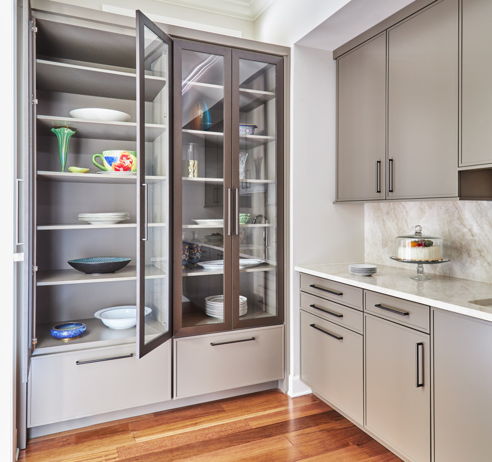 Inspiration for a large transitional l-shaped kitchen pantry remodel in Chicago with an undermount sink, flat-panel cabinets, medium tone wood cabinets, quartzite countertops, beige backsplash, stone tile backsplash, paneled appliances, an island and white countertops