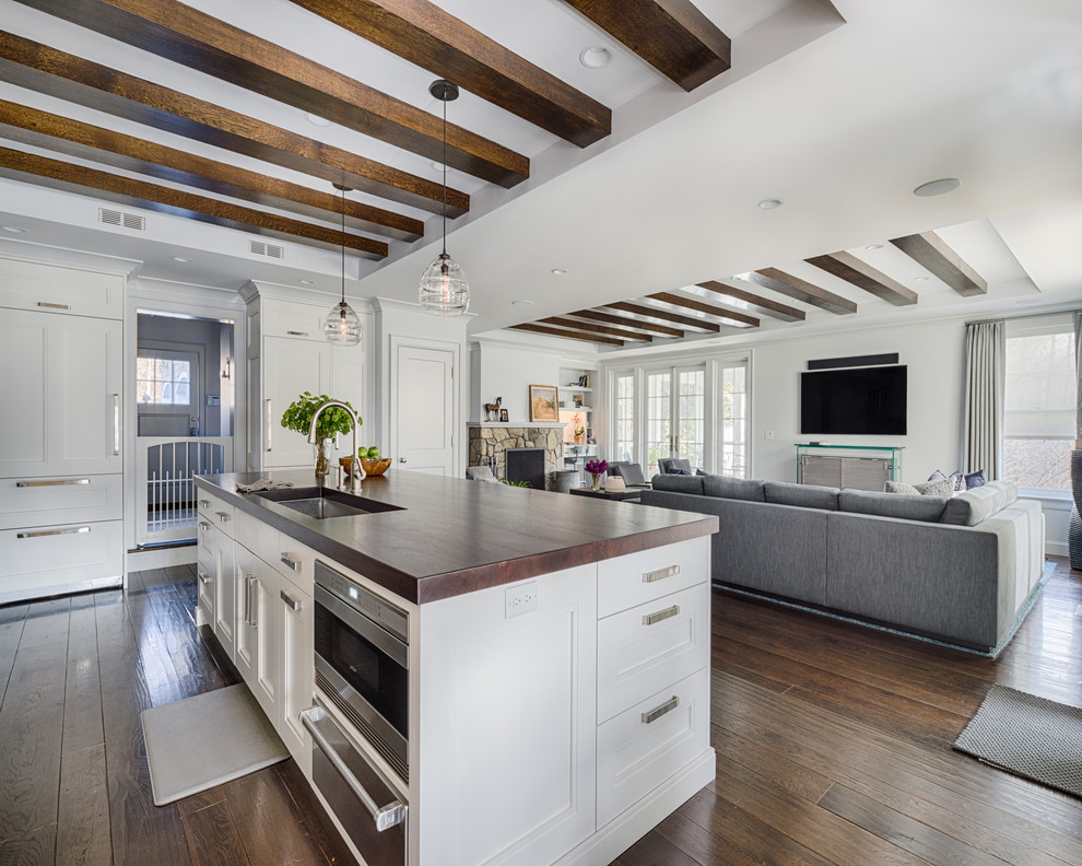Mid-sized transitional galley dark wood floor eat-in kitchen photo in Boston with recessed-panel cabinets, white cabinets, wood countertops, stainless steel appliances, an island, an undermount sink, gray backsplash and stone tile backsplash