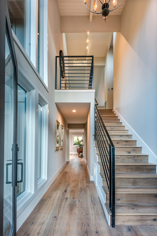 Design ideas for a small modern wood straight staircase in San Francisco with wood risers and metal railing.