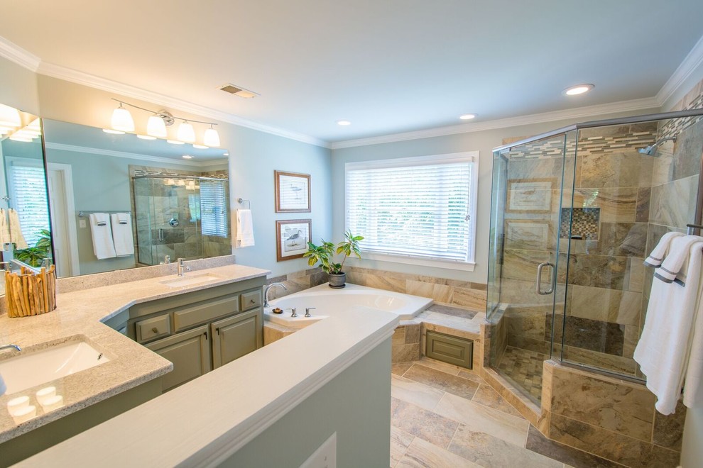 Photo of a large transitional master bathroom in Raleigh with raised-panel cabinets, green cabinets, a drop-in tub, a corner shower, a two-piece toilet, multi-coloured tile, stone slab, green walls, slate floors, an undermount sink and laminate benchtops.