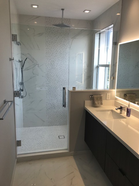 Photo of a mid-sized contemporary 3/4 bathroom with a corner shower, a one-piece toilet, white tile, porcelain tile, purple walls, porcelain floors and a pedestal sink.