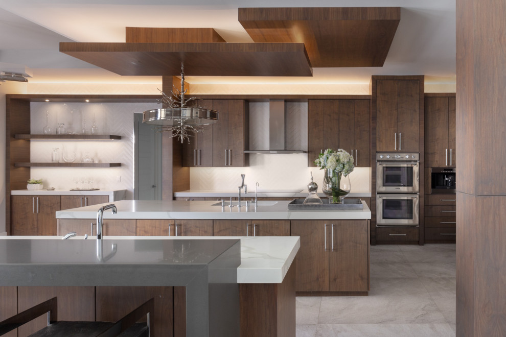 Design ideas for a contemporary galley kitchen in Other with an undermount sink, flat-panel cabinets, dark wood cabinets, white splashback, stainless steel appliances, multiple islands, grey floor and white benchtop.