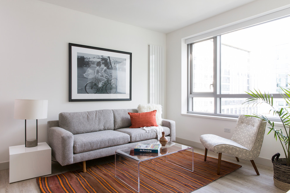 Example of a mid-sized danish open concept and formal light wood floor living room design in San Francisco with white walls