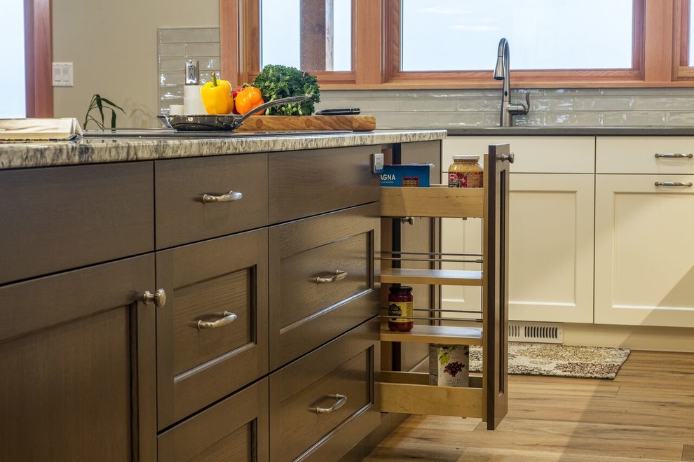 Kitchen - large transitional medium tone wood floor kitchen idea in Seattle with an undermount sink, shaker cabinets, white cabinets, granite countertops, white backsplash, subway tile backsplash, stainless steel appliances and an island
