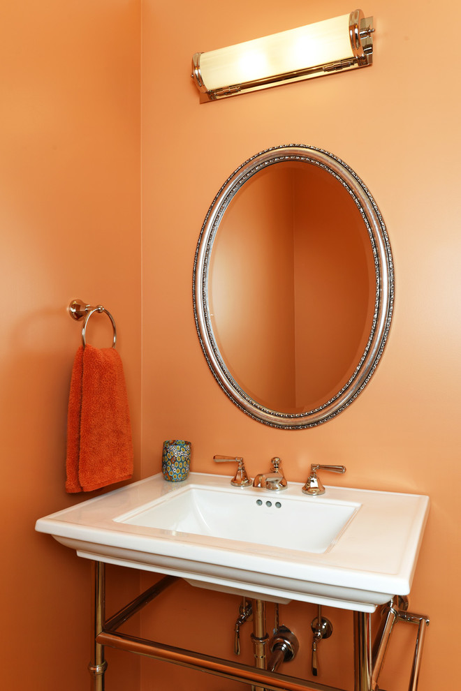 Design ideas for a mid-sized transitional powder room in San Francisco with orange walls and a pedestal sink.
